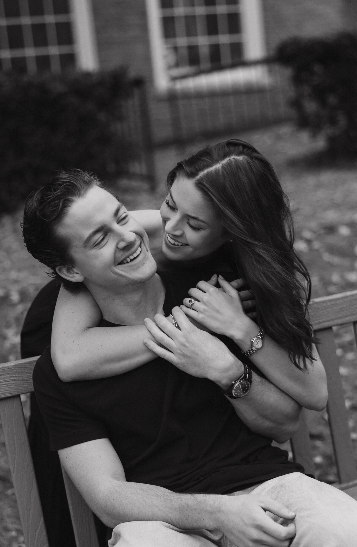 engaged couple laughing with each other candid photo