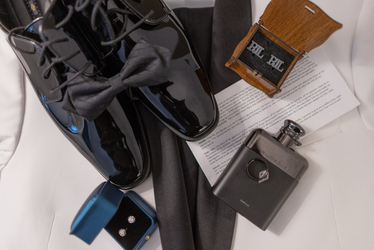 Groom's wedding shoes, cologne, cuff links, and ring