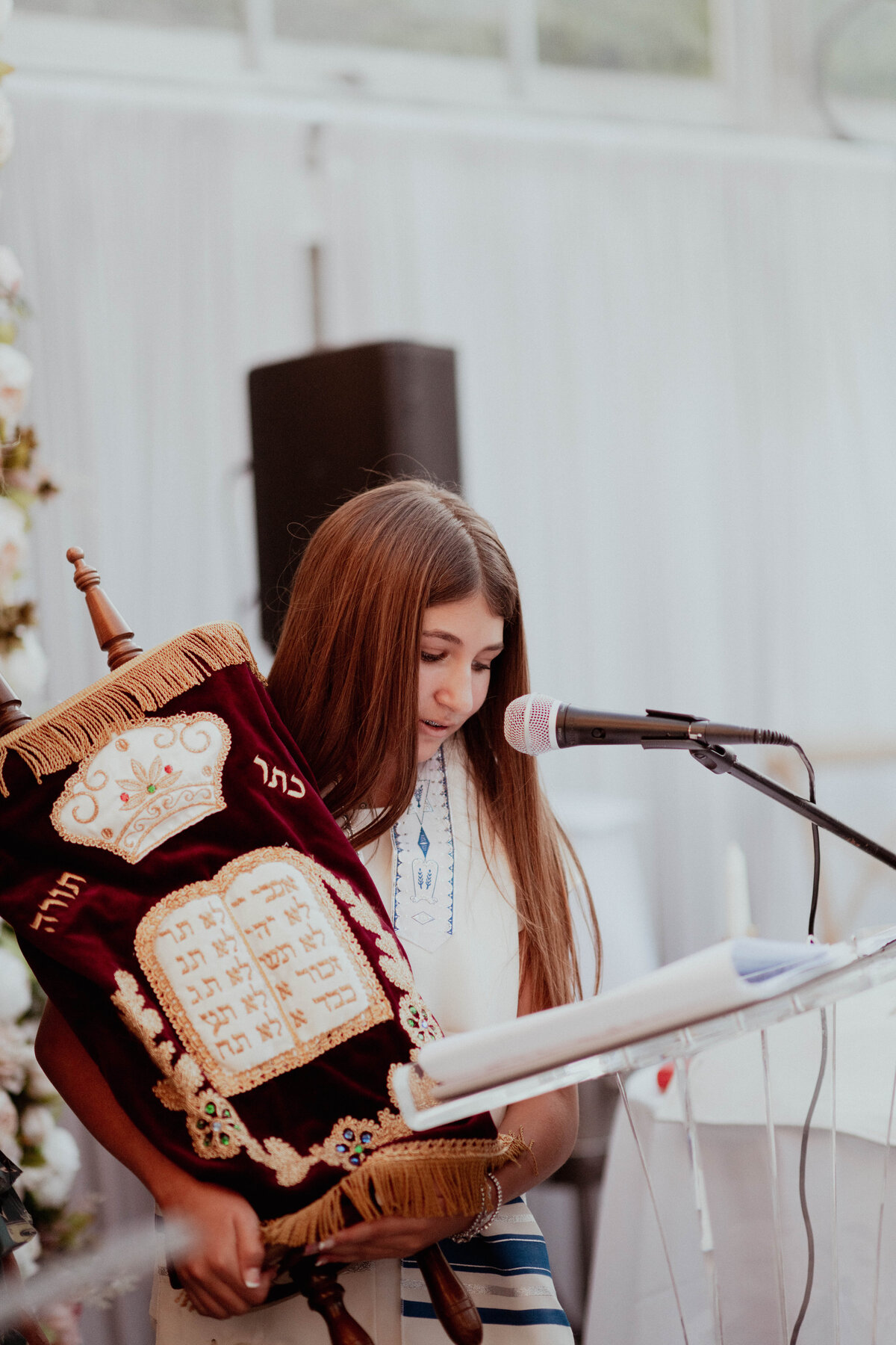 Bat Mitzvah ceremony in Alpine, NJ with the guest of honor reading from the Torah.