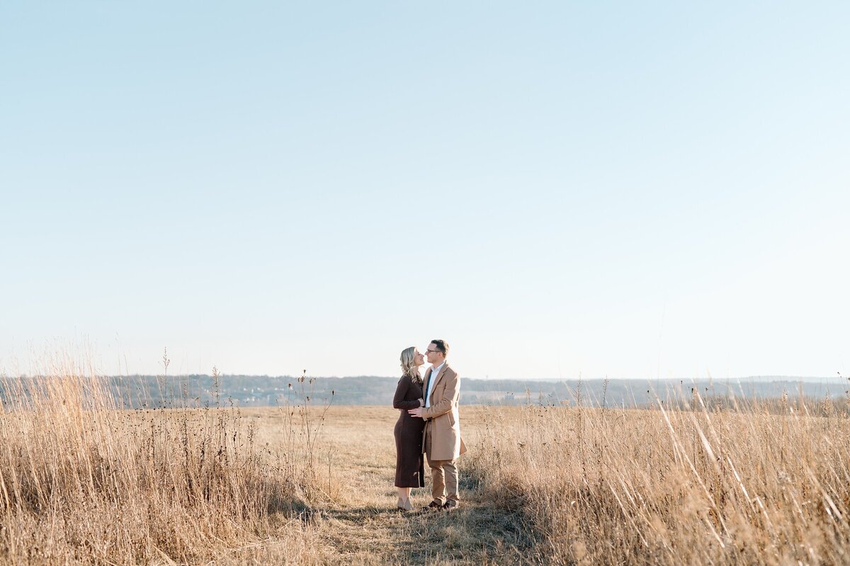 Pulled back image of parents in a field in Waukesha, Wisconsin