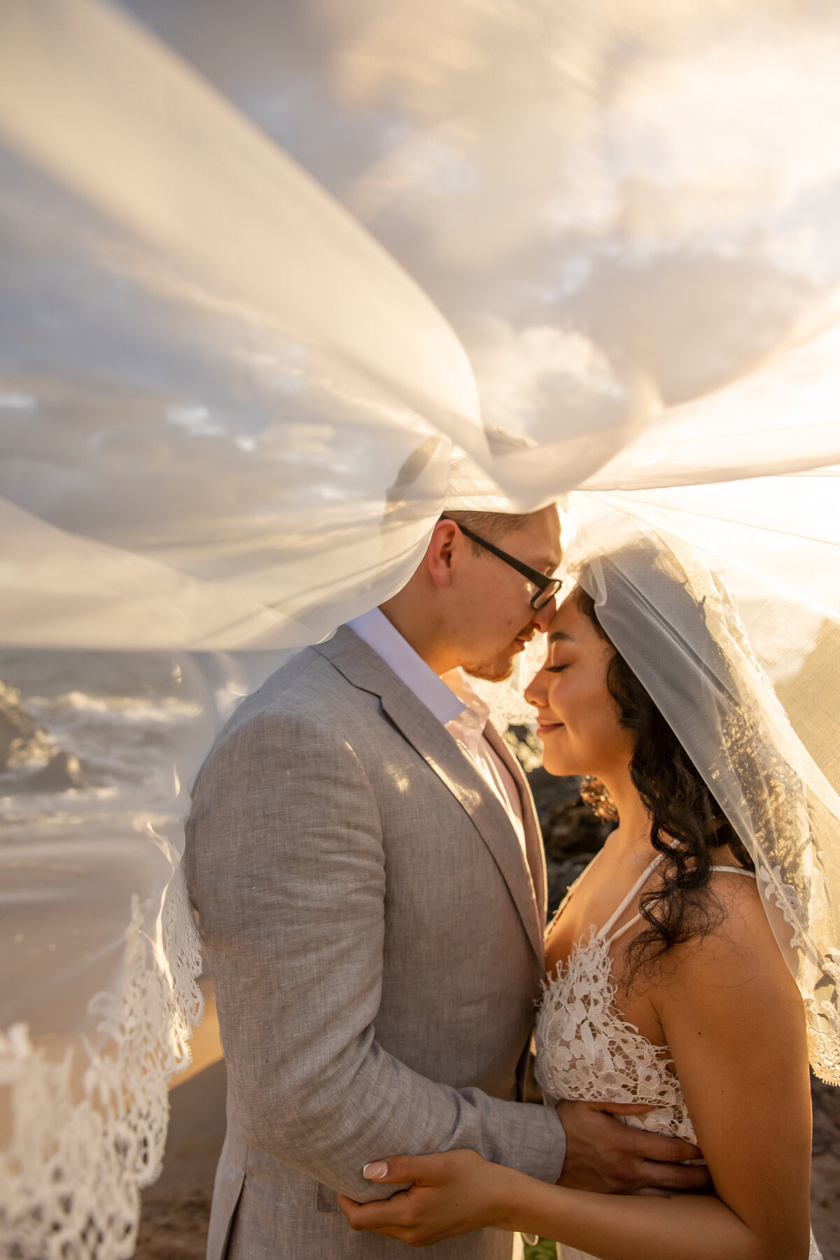 Maui Wedding Photographer captures bride and groom under veil after Maui beach wedding