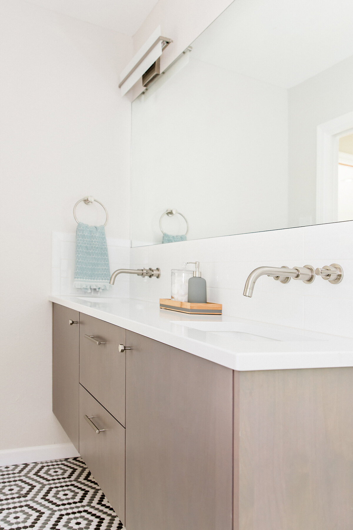 Fresh, modern bathroom remodel with floating vanity and hex tile floor - designed by Patina Living co.