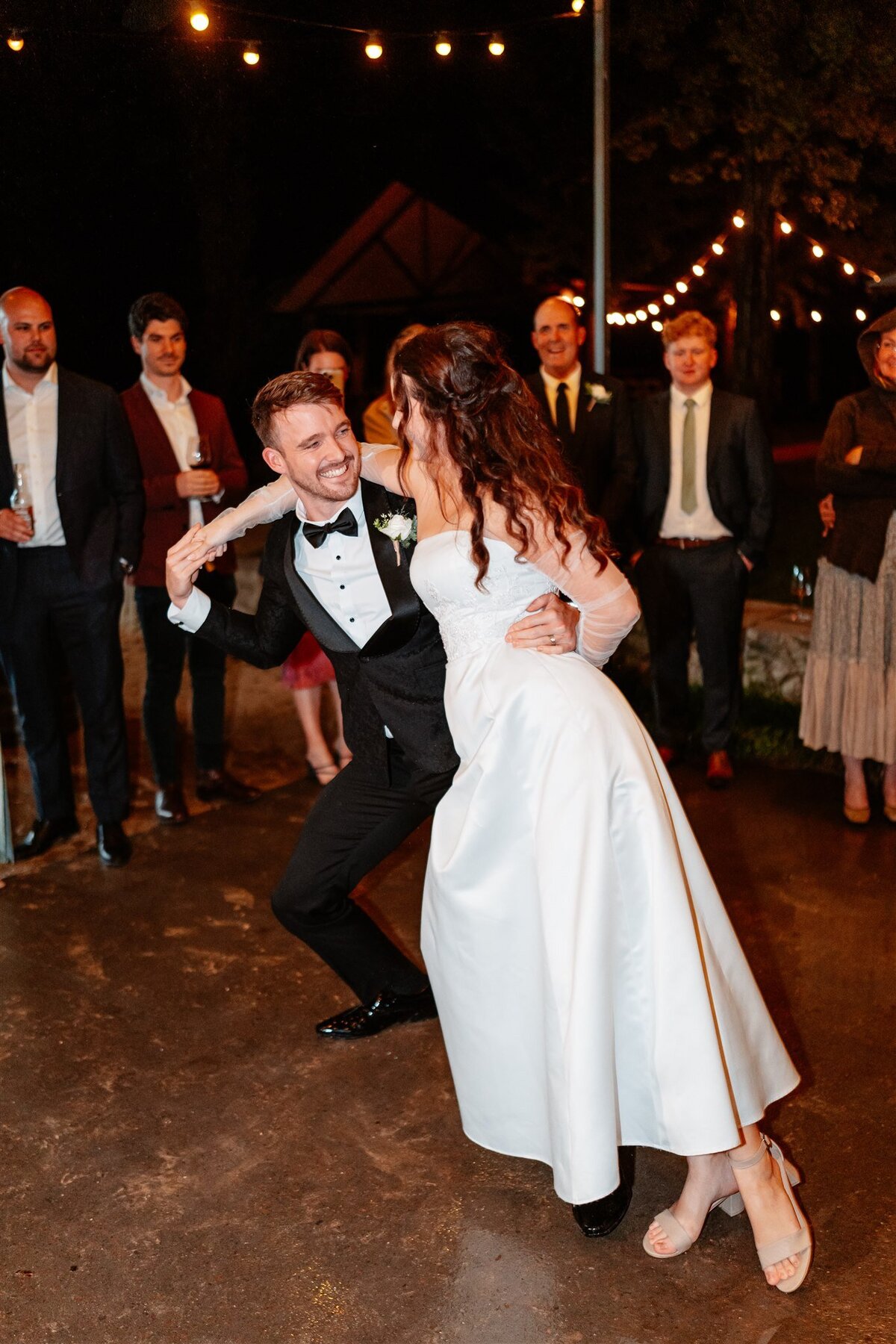 A blissful moment captured: a couple joyfully dances at their wedding reception, encapsulating love and celebration in a single frame.