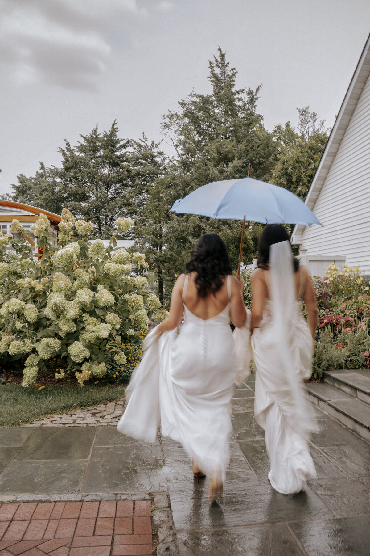luxury-lgbtq-wedding-maryland-two-brides-holding-umbrella