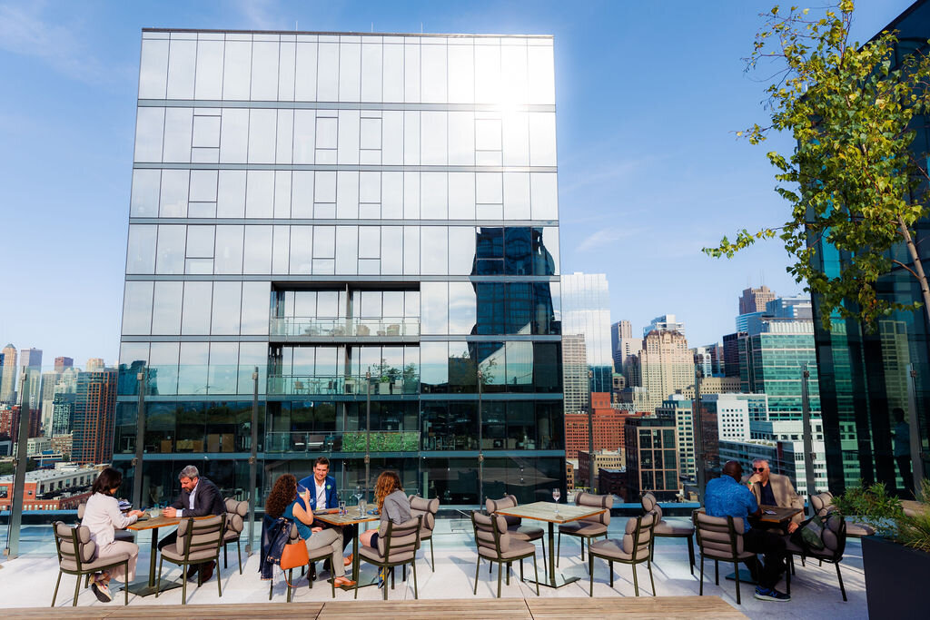People sit at tables outdoors.