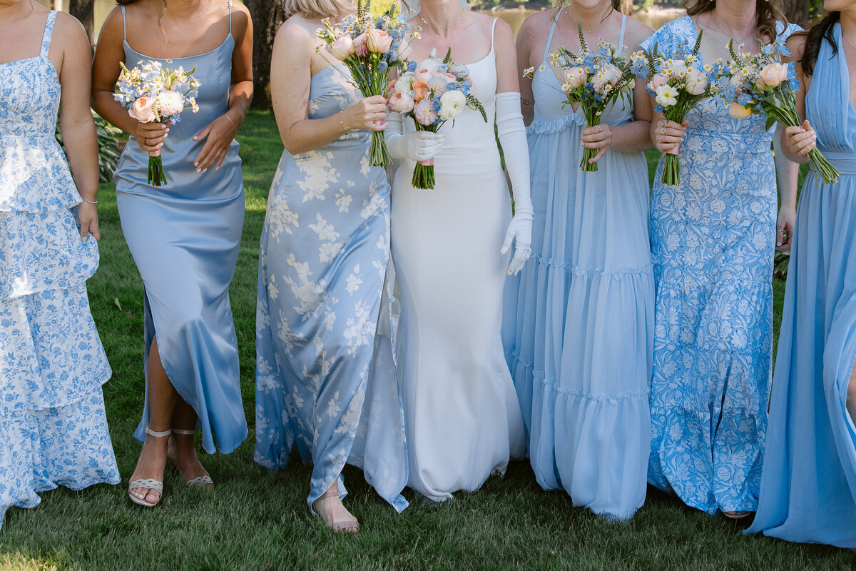 bride-and-bridesmaids-walking-wedding-photos-at-saint-clements-castle