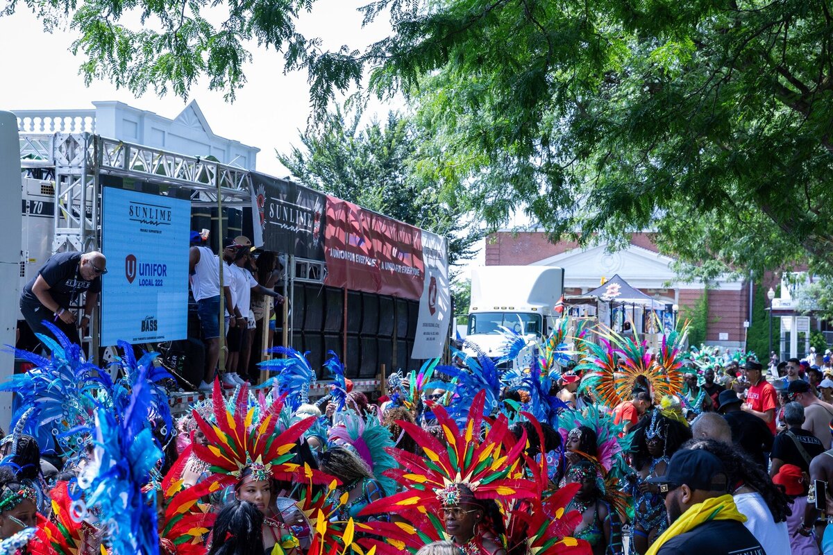 Toronto caribbean carnival parade masquerader in costume with Sunlime Mas, the number 1 medium size band at Toronto Carnival.