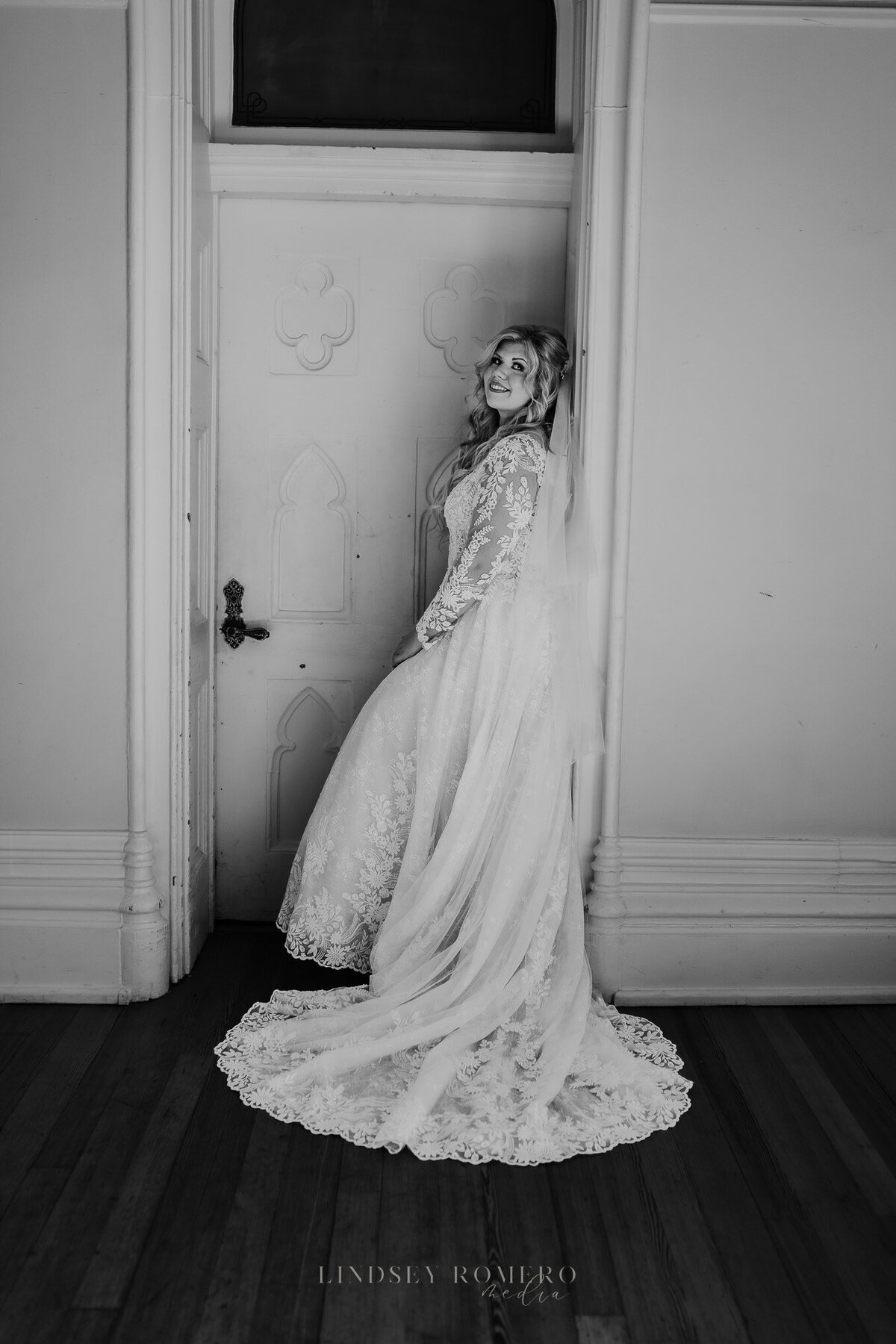 black and white bridal photo and pose with long veil at old state capitol in baton rouge, la
