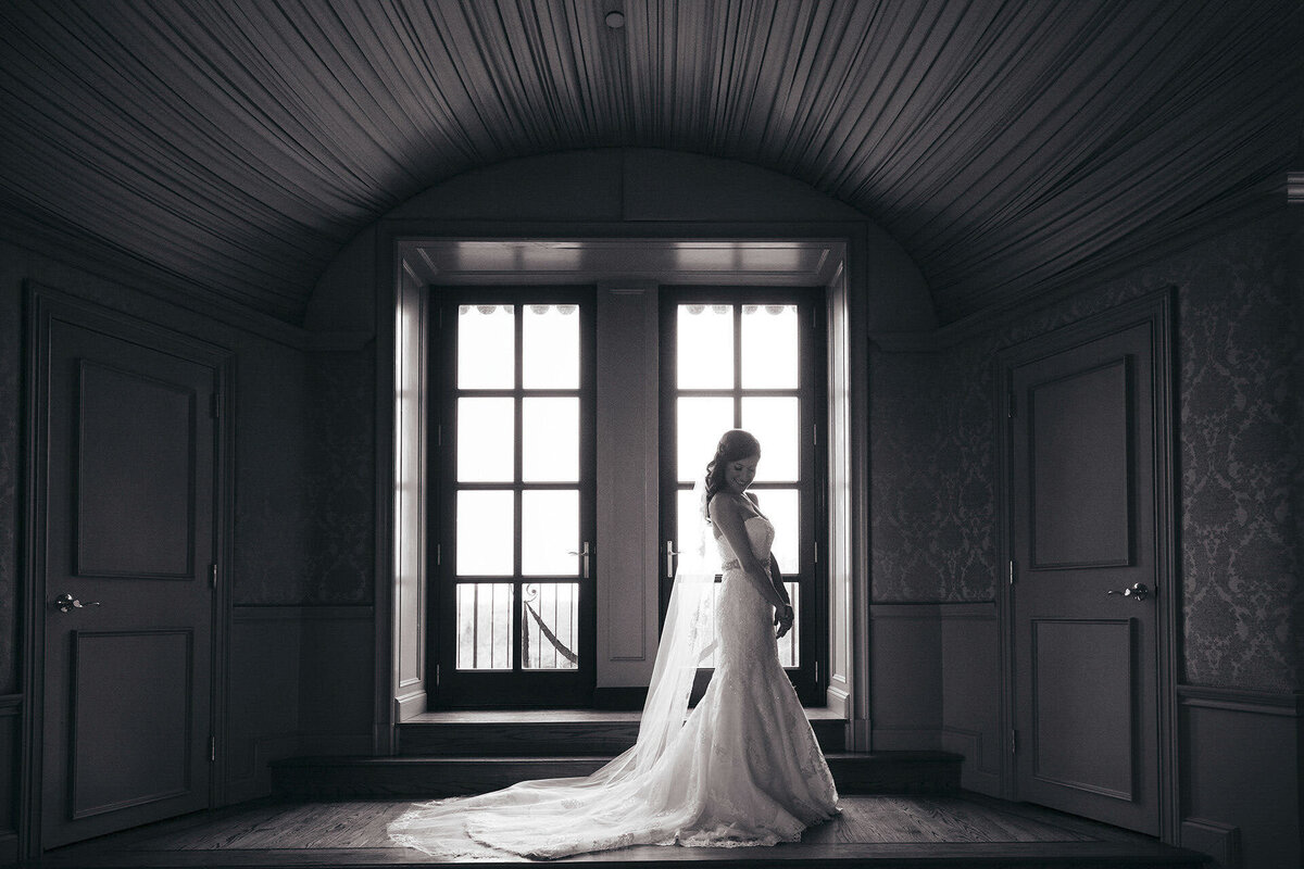 Oheka Castle | Bride posing in bridal suite during wedding preparations | Huntington, New York