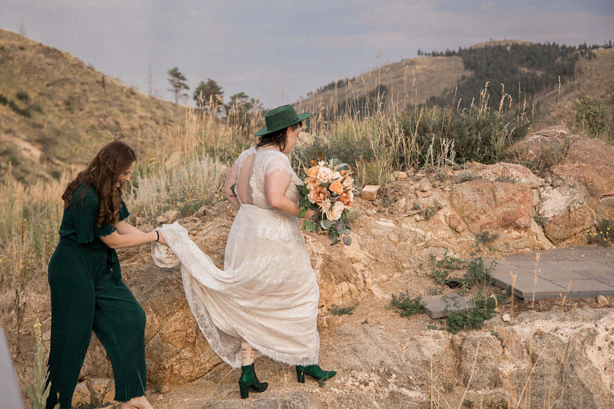 The bride, assisted by her sister-in-law, walks toward her waiting groom.