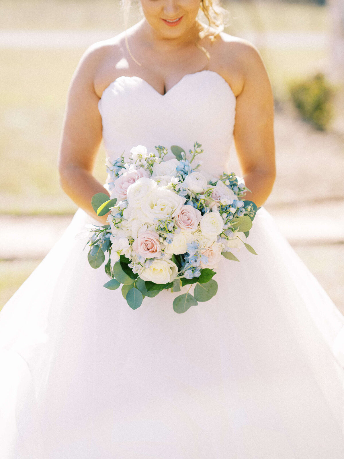 Spring bridal bouquet with light blue, cream, and blush florals