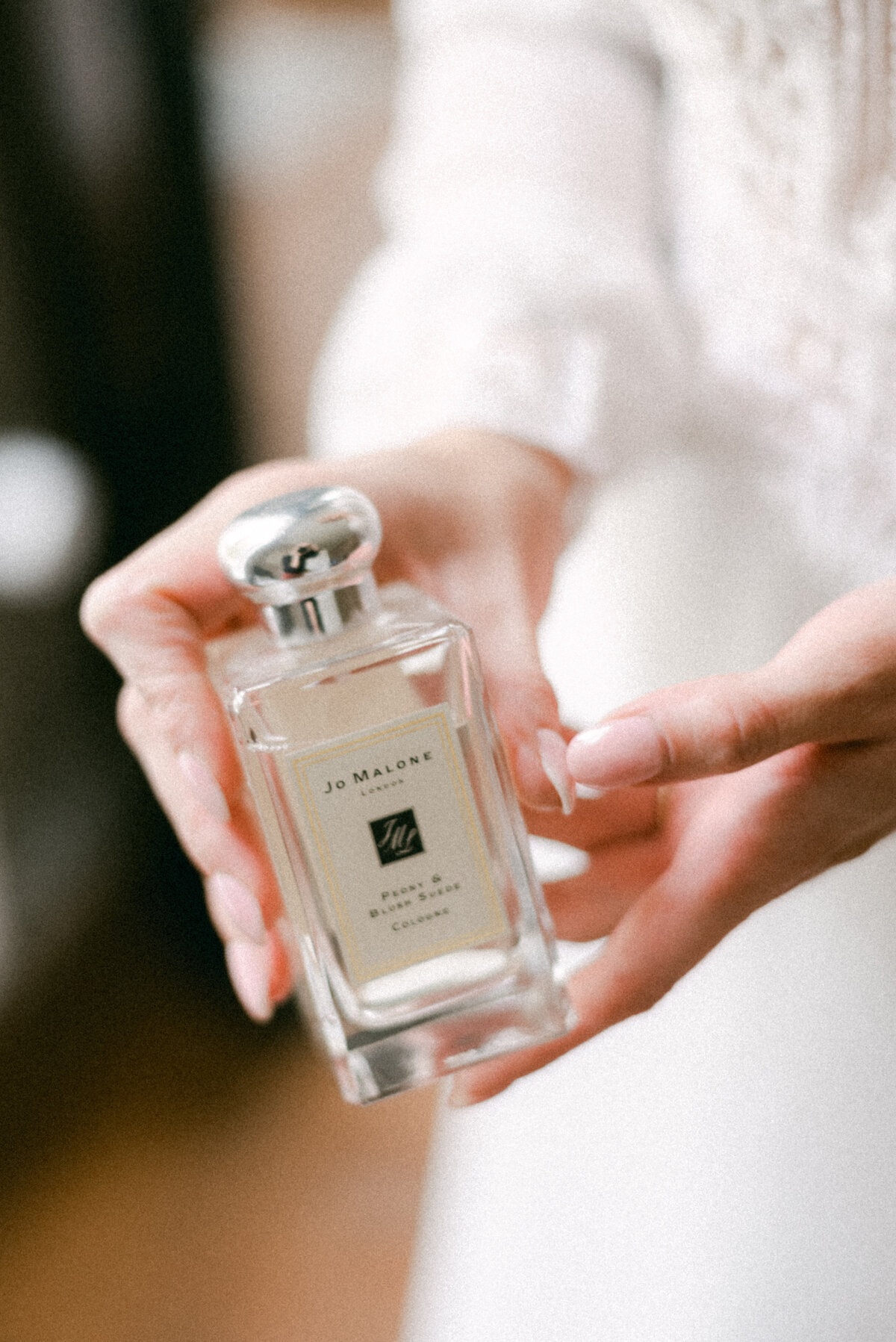 A documentary wedding  photo a bride showing the perfume in Oitbacka gård captured by wedding photographer Hannika Gabrielsson in Finland