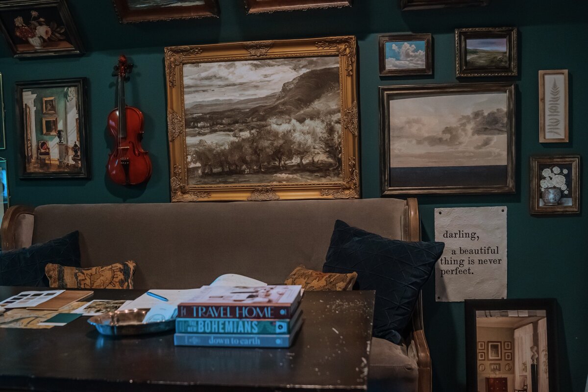 Gallery wall with sofa bench and wrought iron table