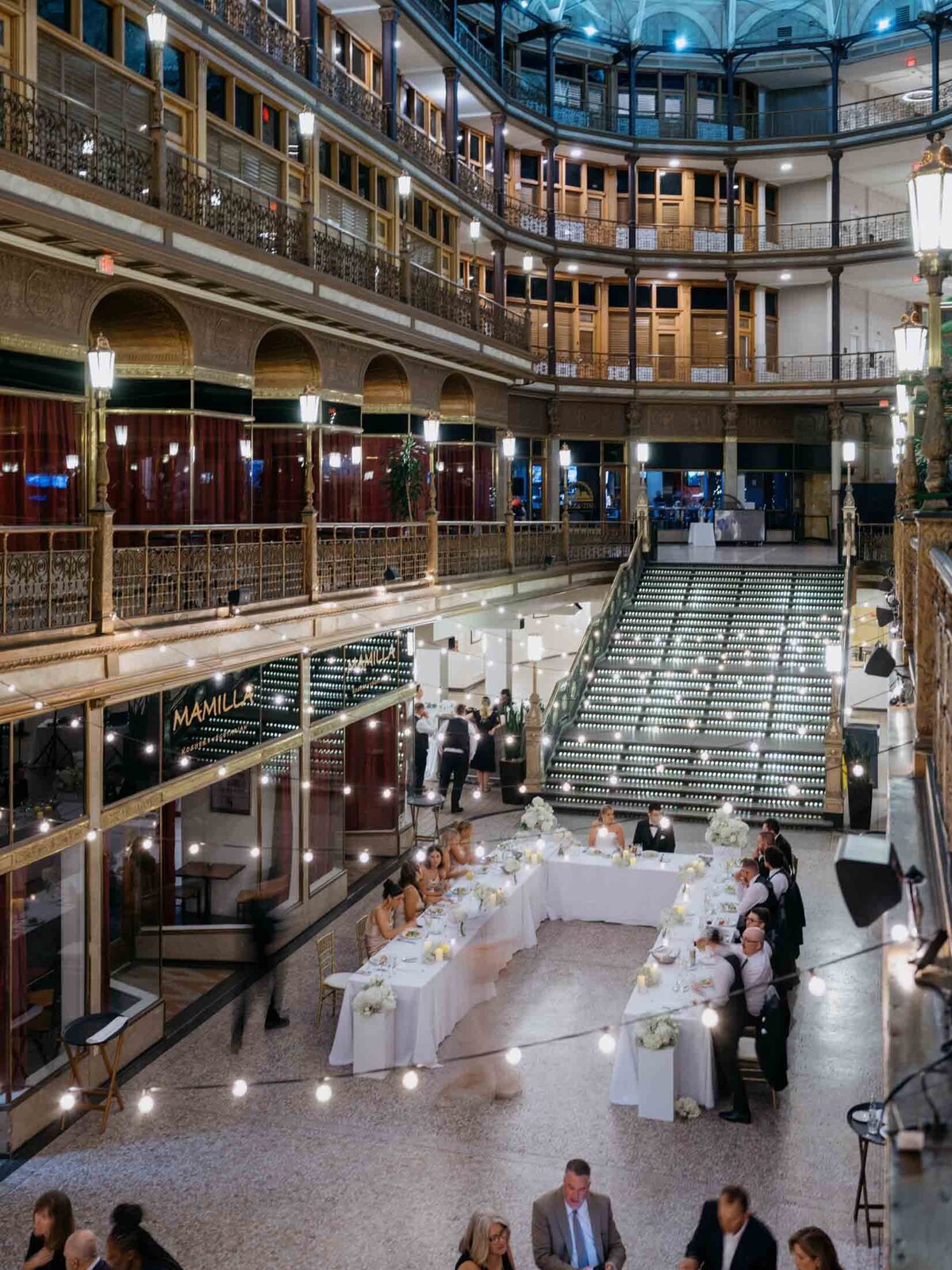 Overhead view of reception at The Arcade with string lights and modern decor