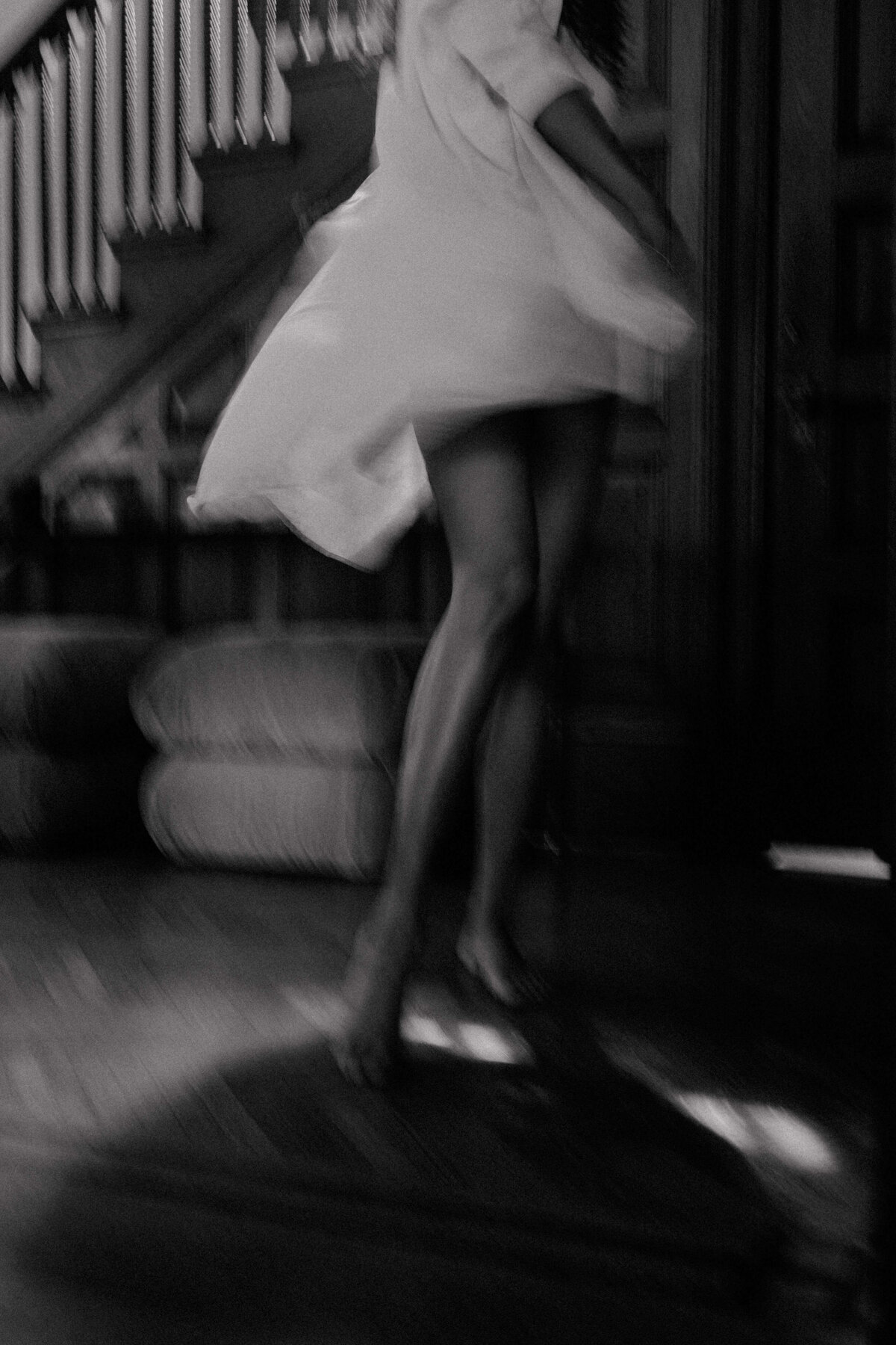 Black and white photo of a dancing website copywriter passionate about her career