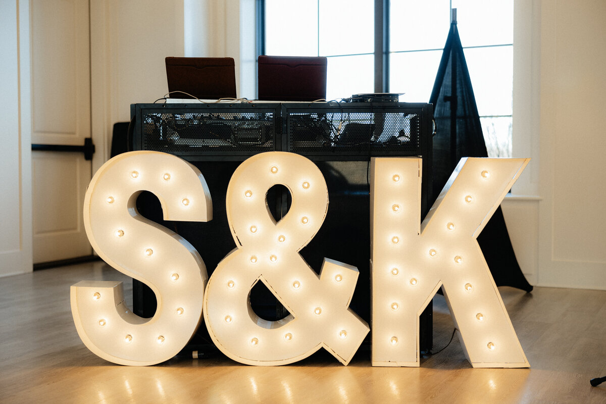 Large S & K letters in front of the DJ stand.
