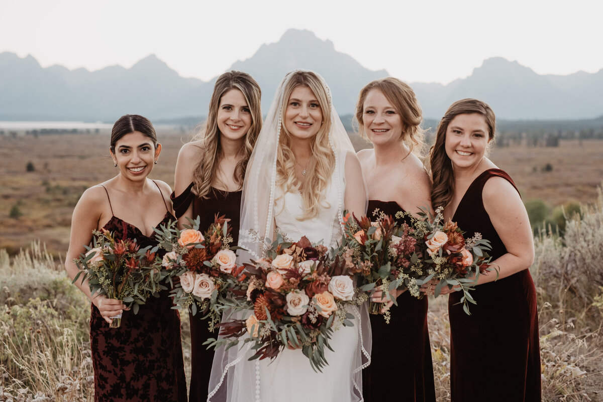 Photographers Jackson Hole capture bride standing with bridesmaids