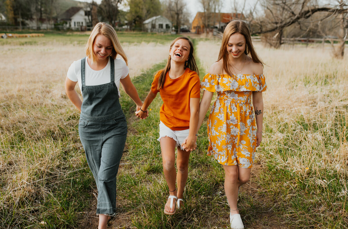 mom and her daughters walking together in family photoshoot