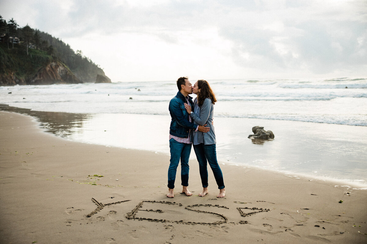 she said yes and got engaged in the sand photos by the best wedding photographer in portland oregon