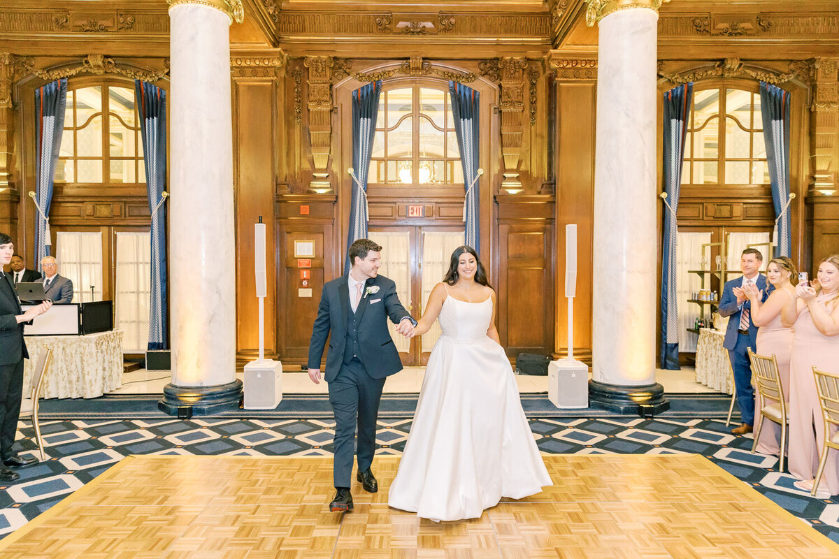 Couple walking together inside grand ballroom