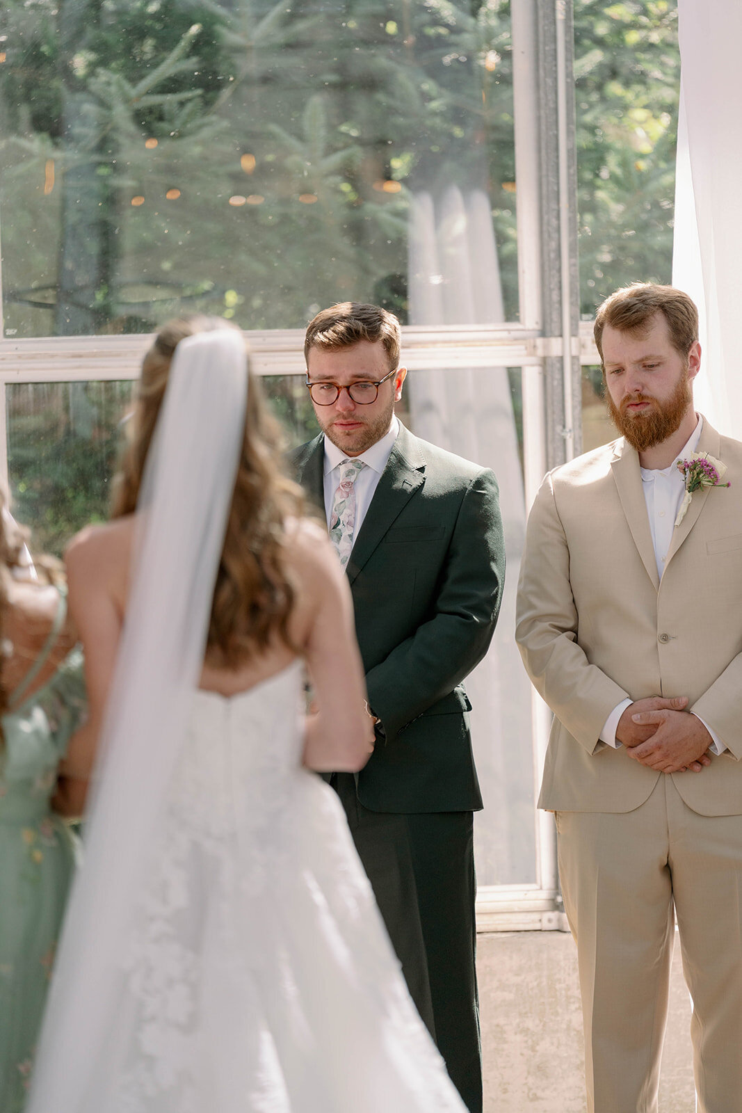 Groom tearing up as he sees his bride walking down the aisle during their Ivy House wedding in Saugatuck, MI.