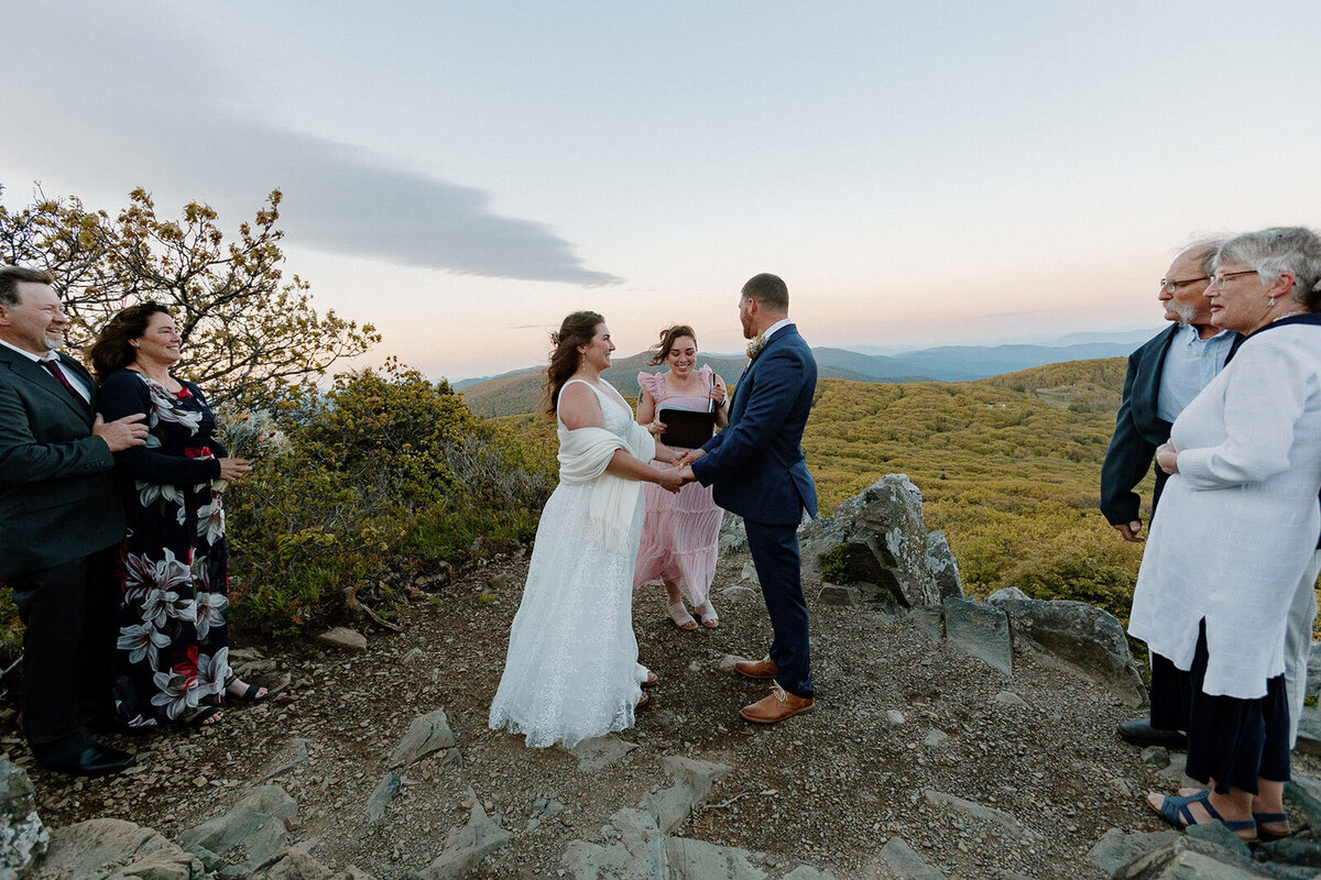 A bride and groom exchanging vows in front of a gorgeous view in Virginia