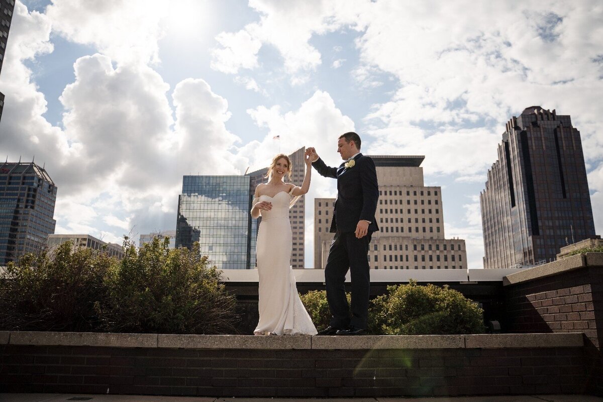 bride-and-groom-spin-rooftop-wedding-jps-events-indianapolis-skyline.jpg