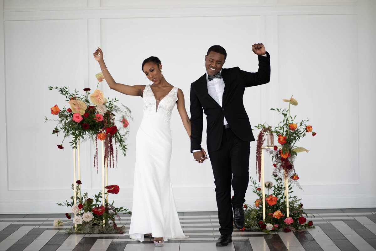 Bride-and-groom-arms-raised