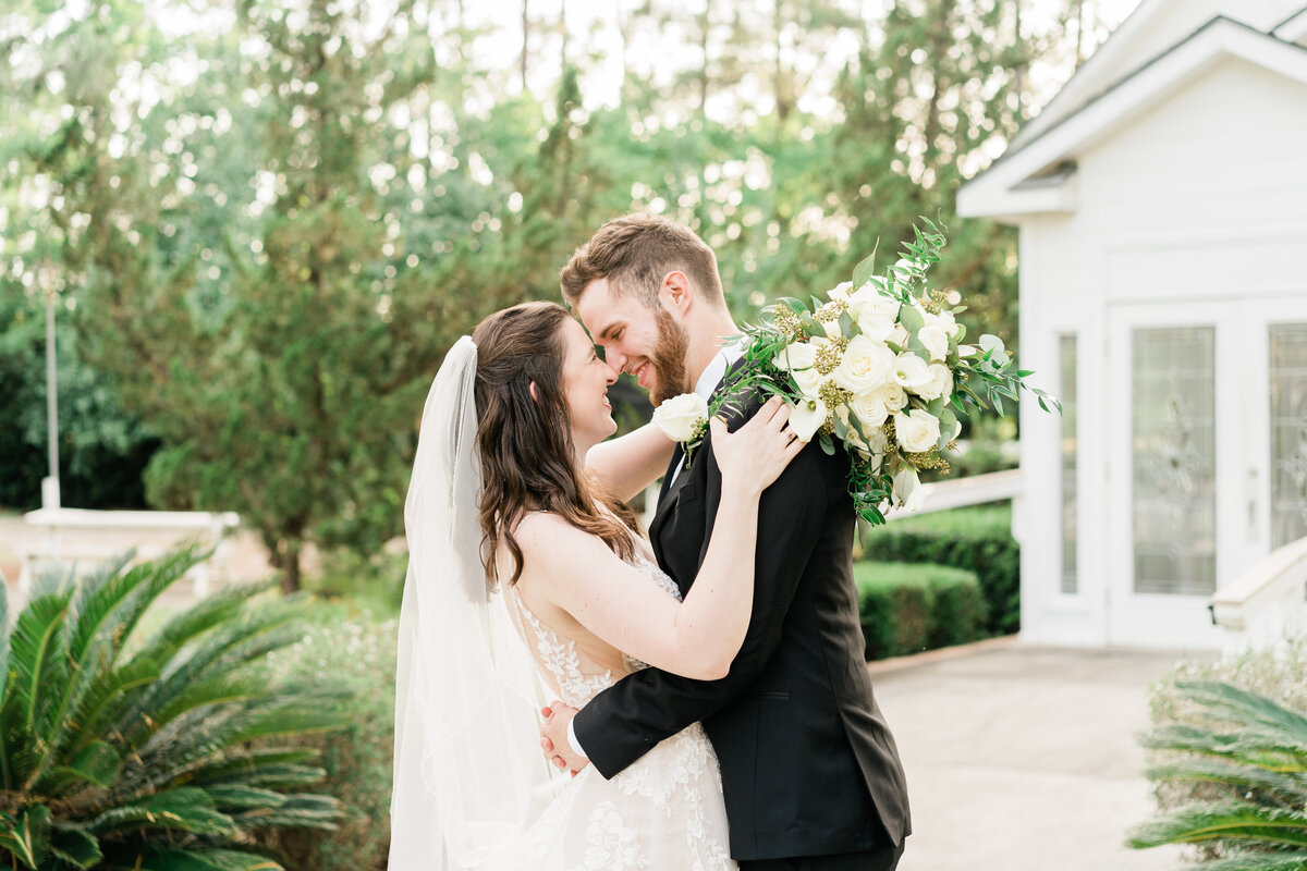 Bride and groom in front of small white church in Alabama