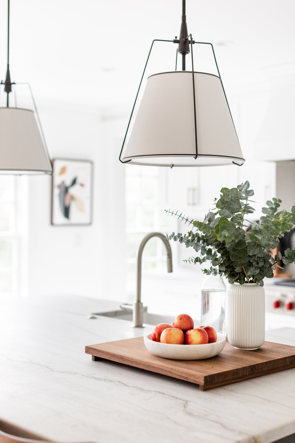 The kitchen island features a White Macaubas quartzite countertop.