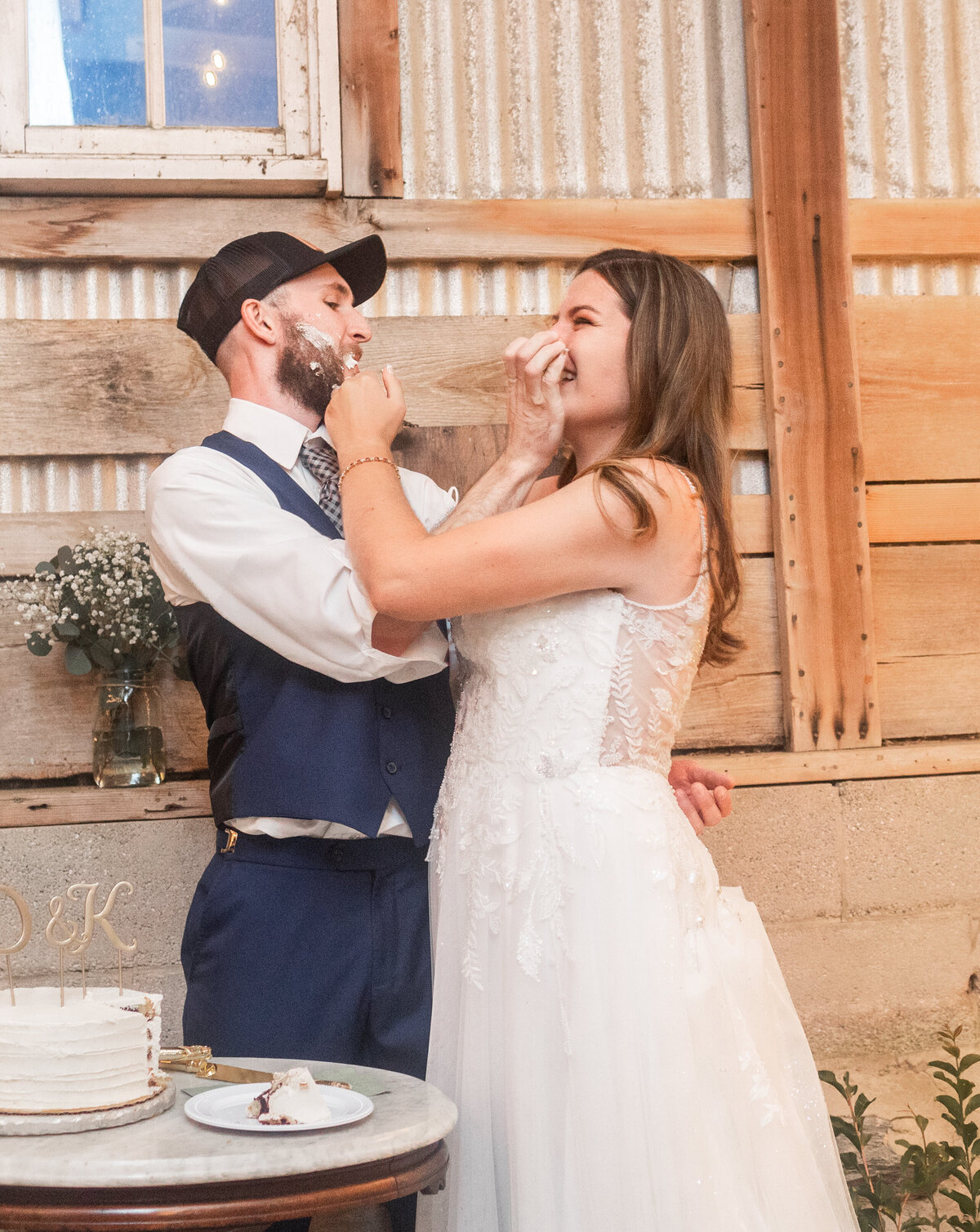 bride and groom in barn  eating wedding cake