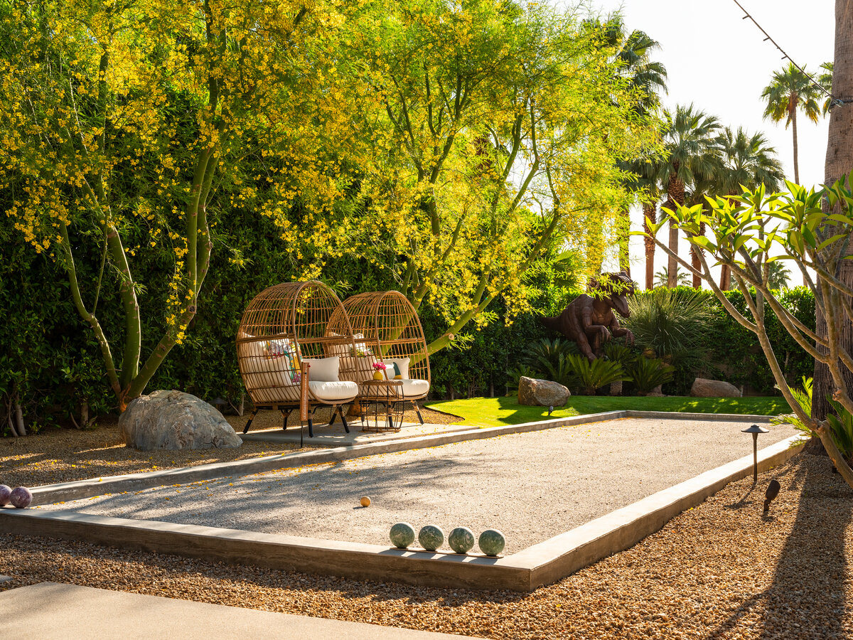 Bocce ball court amid palo verde trees and lush desert landscape in Palm Springs designed by Los Angeles architect.