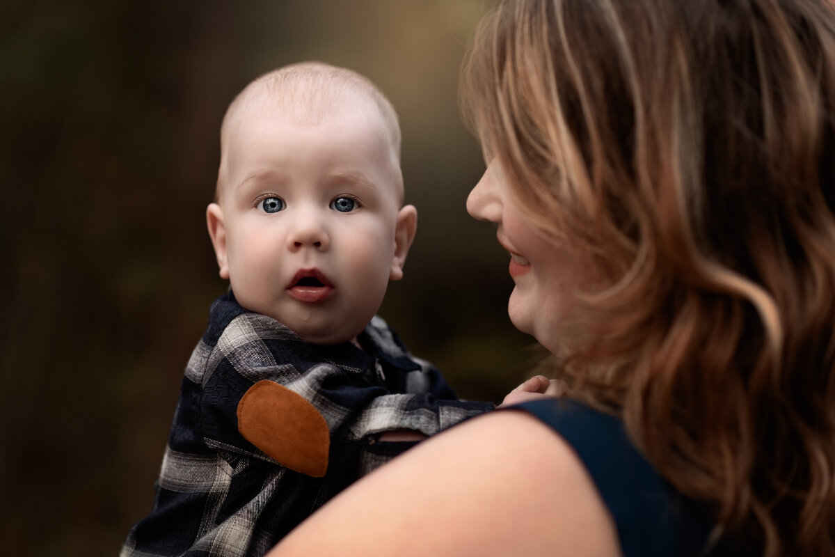 Outdoor milestone moment between mother and baby—captured in warm fall tones during a session in Ayr, Ontario.
