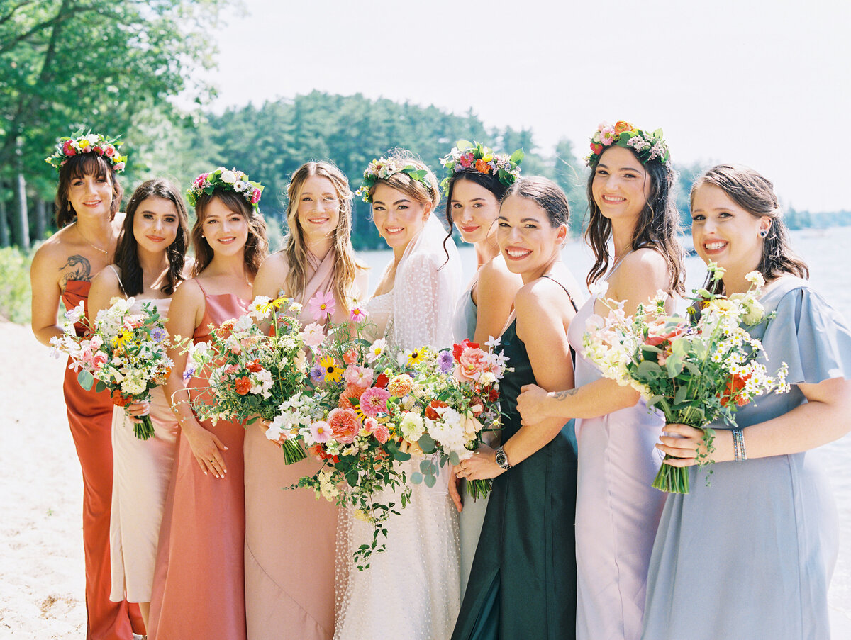 bride with bridesmaids wearing colorful dresses with colorful bouquets for New Hampshire wedding