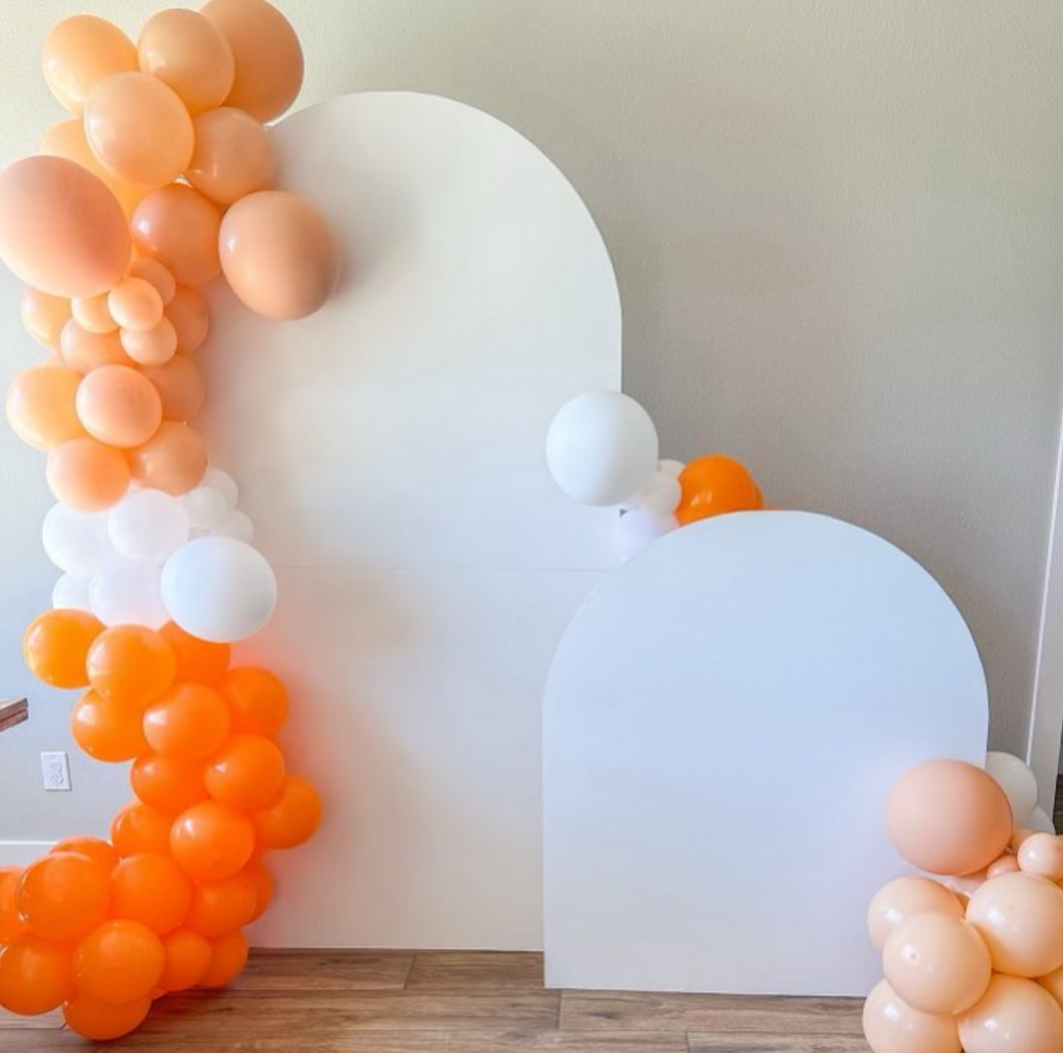 orange and white balloons with backdrop