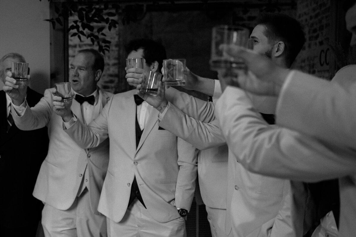 Groomsmen share a toast before the grooms wedding ceremony at the Cotton Press in Little Mountain, SC.