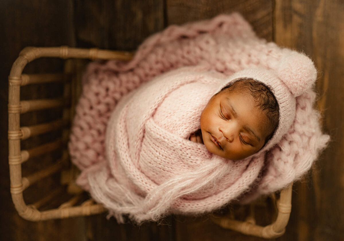 newborn baby girl swaddled in pin knit in Suwanee newborn  studio
