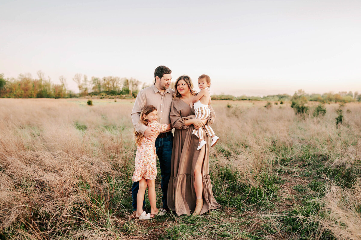 Branson family photography of family hugging in field