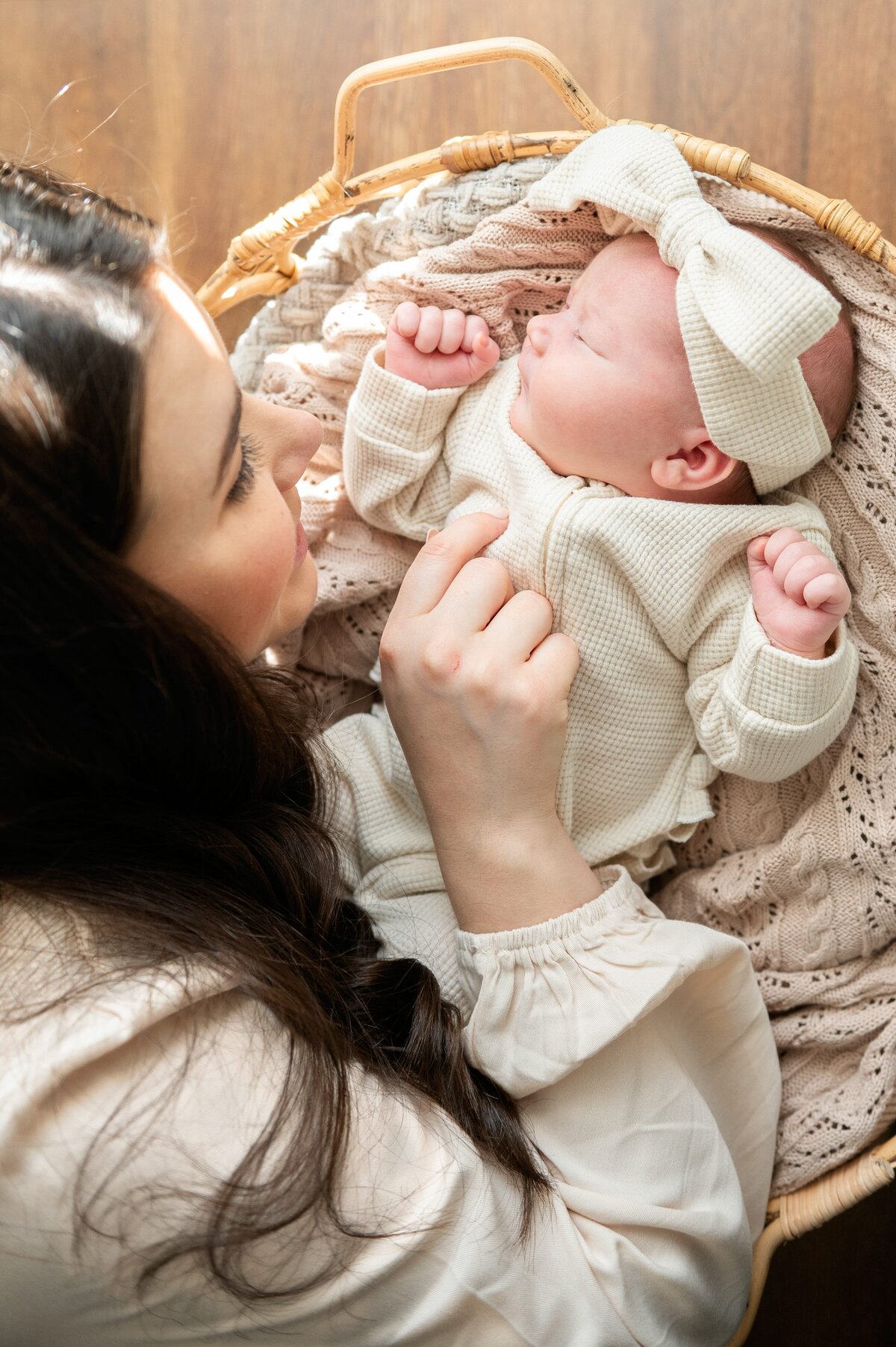 mom looking at baby in basket
