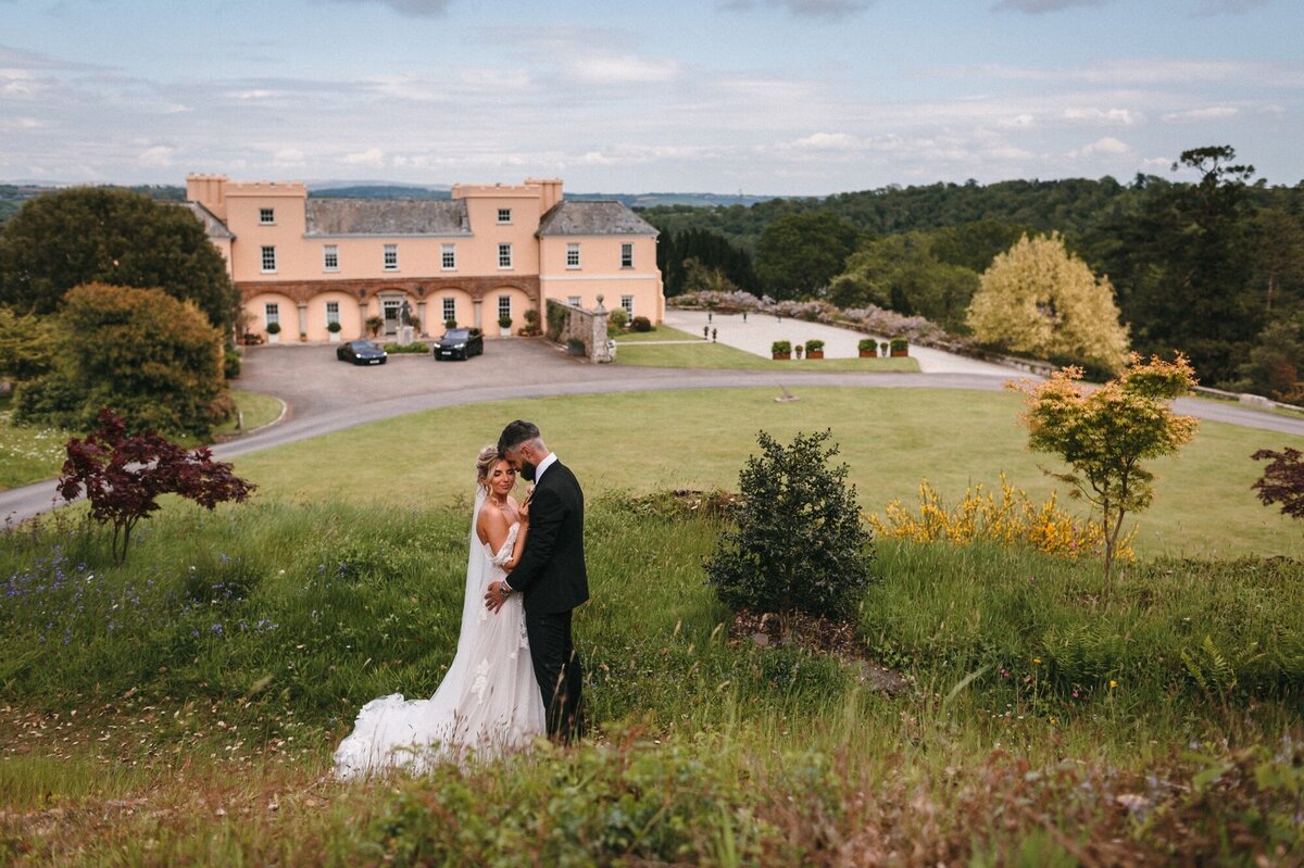 Couple kiss in front  of Pentillie Estate 