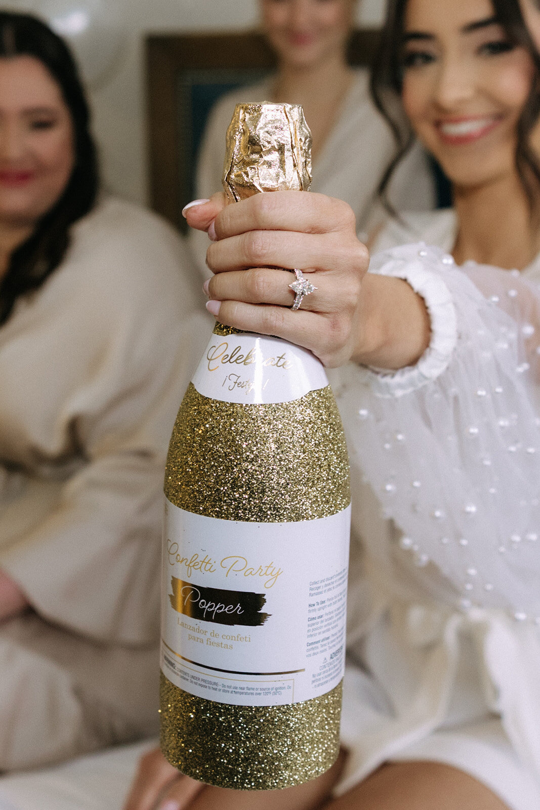 bride holding champagne with ring at bella collina weddings & events​