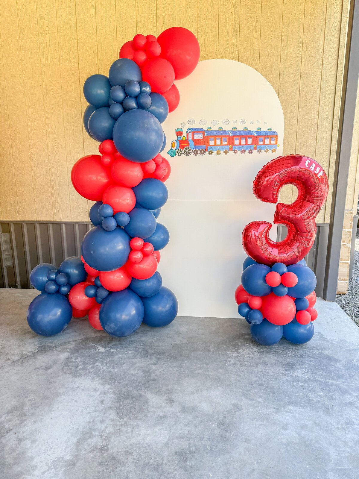 train balloons, red and blue with birthday number balloon