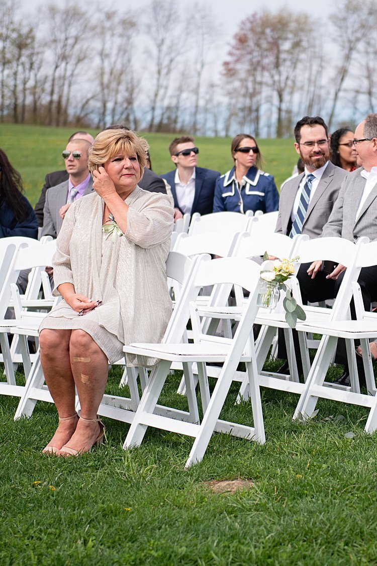 Mother of the Bride sits and waits for outdoor wedding ceremony to begin at White Barn in Prospect, PA