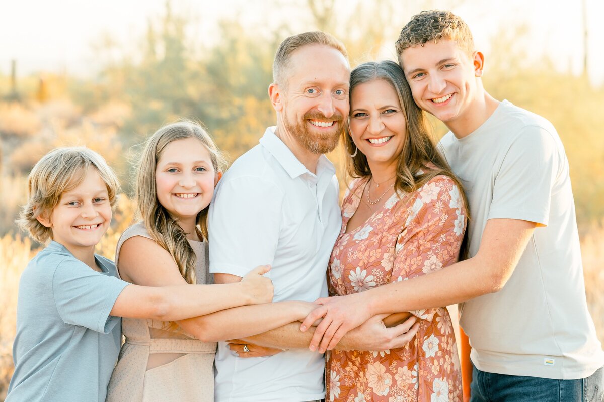 family hugging each other in the north scottsdale desert 