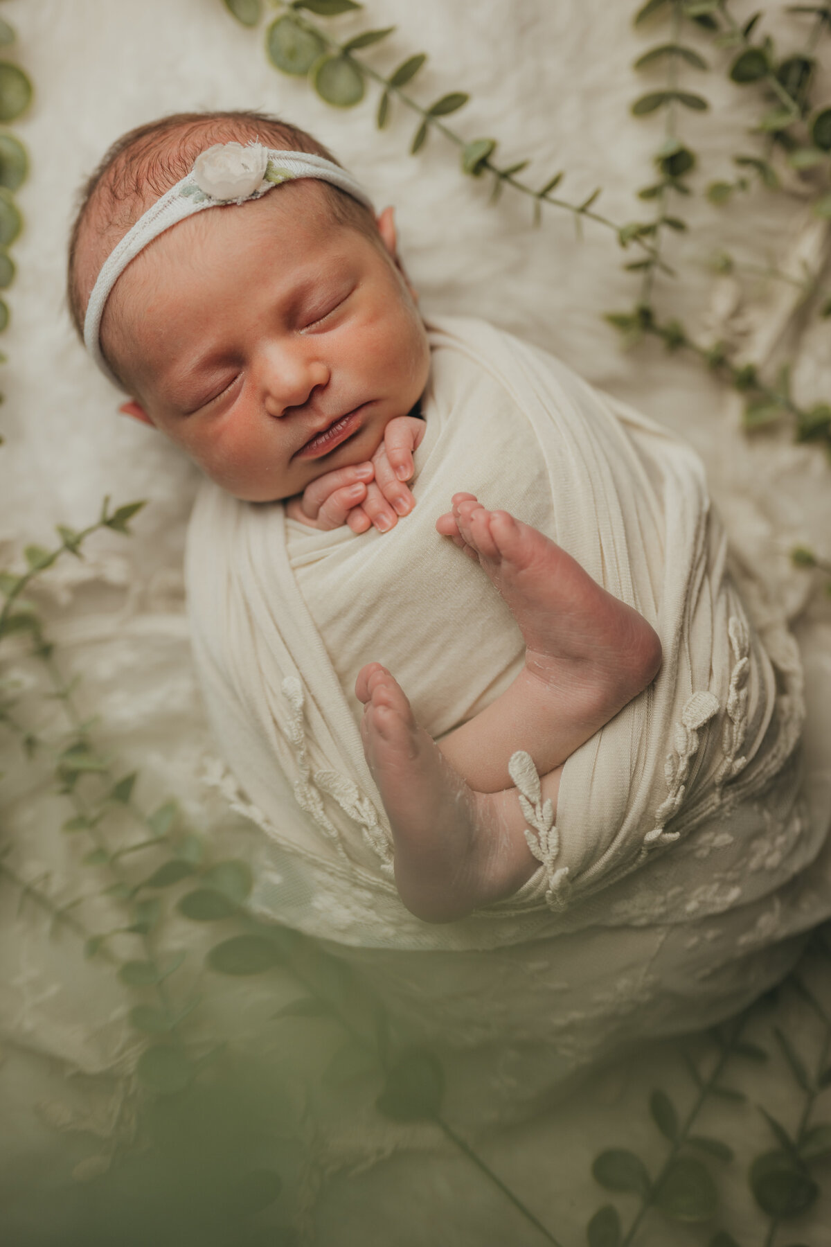 newborn-baby-girl-flowers-swaddled