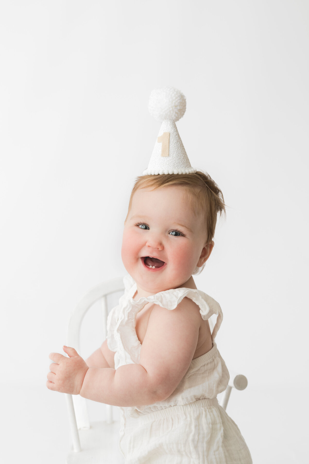 Hobart Baby wearing a party hat at a 1st birthday photoshoot