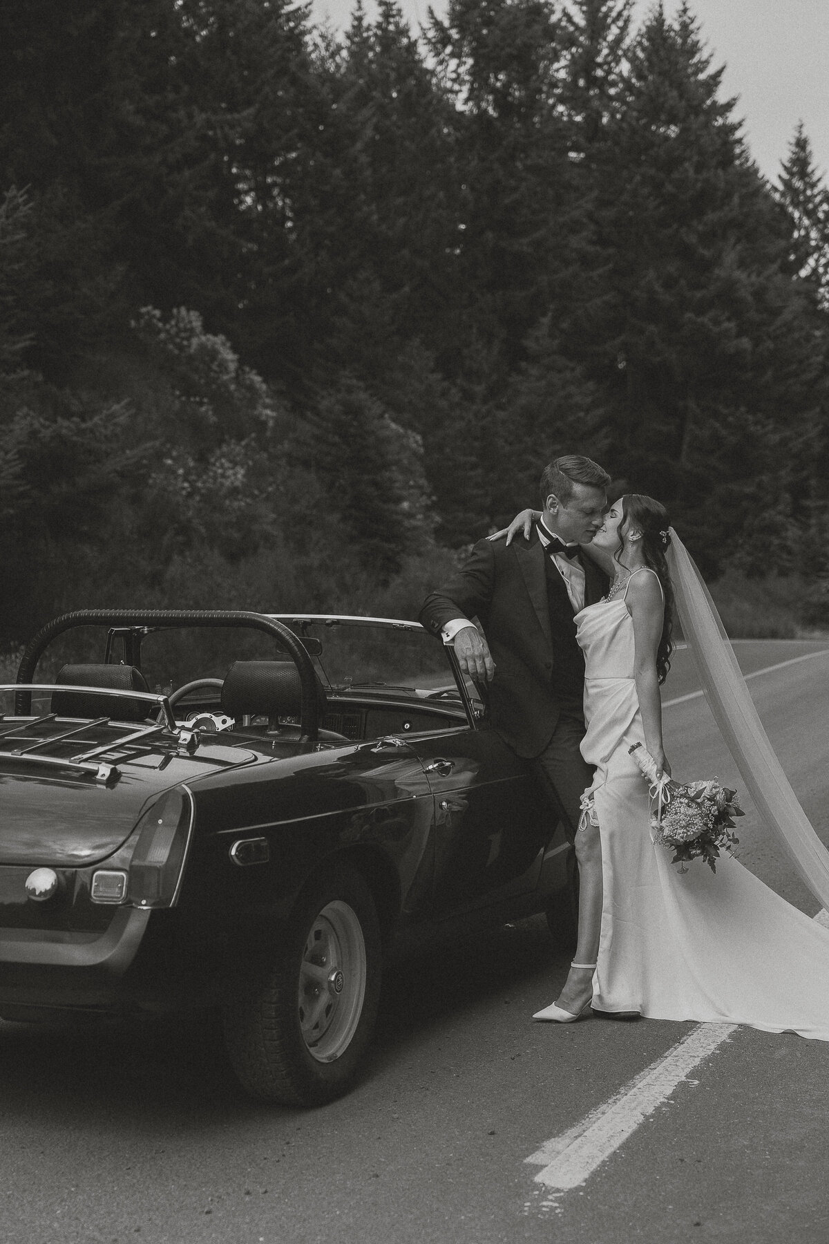 Bride and groom in front of their MGB during their wedding portraits at Caleb Pike Heritage Park in Victoria by Latitude 49 Photography