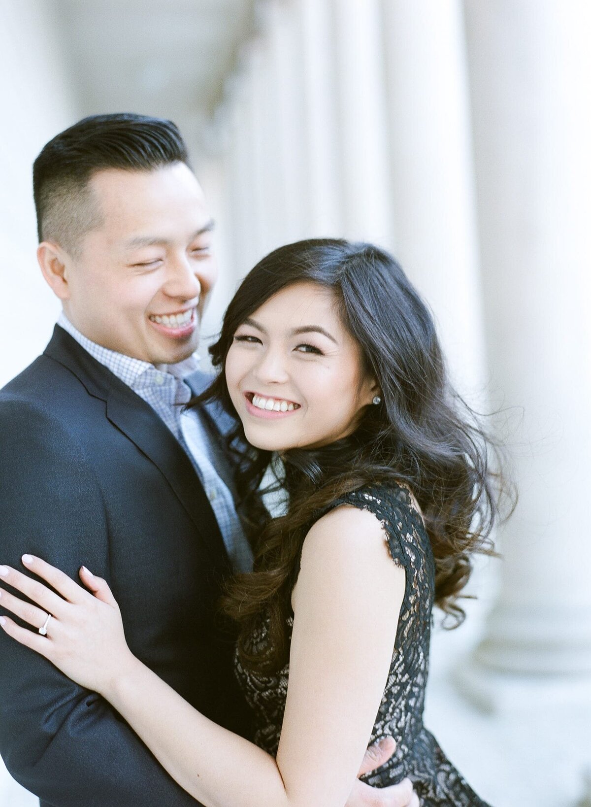 A newly engaged couple embrace each other and pose for Engagement Photographer Robin Jolin.
