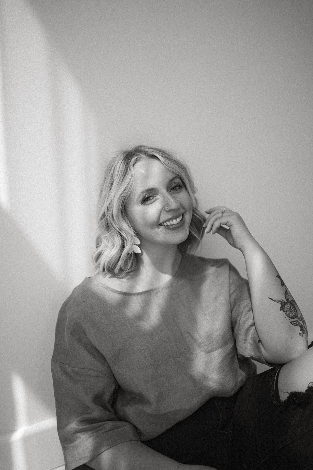Black and white photo of a woman smiling during a Wildher and Co studio branding session in Kalamazoo Michigan.