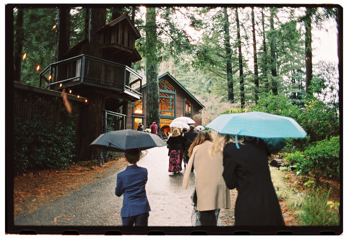 A wide film photograph of a misty mountain landscape on a rainy wedding day, evoking warmth, romance, and nostalgia in Kate Winters’ documentary style